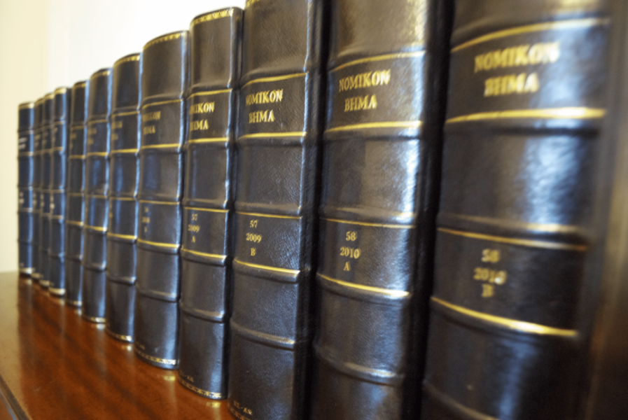 A range of law books aligned on a shelf.